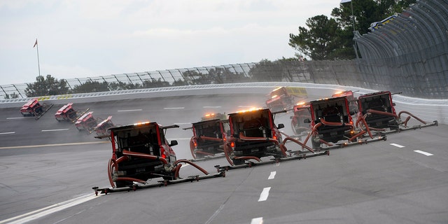 NASCAR attempted to dry the Talladega track with its Air Titan blower trucks.