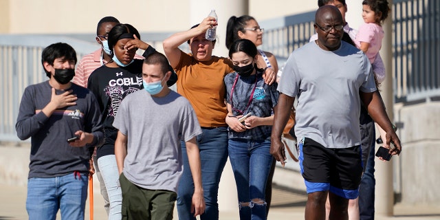 Families depart the Mansfield ISD Center For The Performing Arts Center where families were reunited with Timberview High School Students on Wednesday in Mansfield, Texas. (AP Photo/Tony Gutierrez)