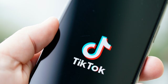 The TikTok logo is seen on an iPhone 11 Pro max in this photo illustration in Warsaw, Poland on September 29, 2020. The TikTok app will be banned from US app stores from Sunday unless president Donald Trump approves a last-minute deal between US tech firm Oracle and TikTok owner ByteDance. US authorities say the Chinese video sharing app threaten national security and could pass on user data to China.