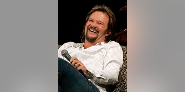 Country artist Travis Tritt laughs during the Celebrity Closeup at the CMA fan festival in Nashville, Tennessee.   Country artist Travis Tritt laughs during the Celebrity Closeup at the Country Music Association Fan Fair in Nashville, Tennessee June 10, 2005. The four day fair is billed as "country music's biggest party" with various country artist performing, signing autographs and participating in various events. REUTERS/Tami Chappell