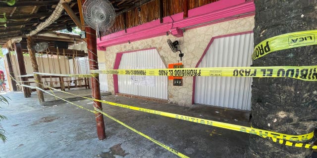 Police security tape covers the exterior of a restaurant the day after a fatal shooting in Tulum, Mexico, Friday, Oct. 22, 2021. (AP Photo/Christian Rojas)