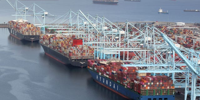 Shipping containers being unloaded from ships at a container terminal at the Port of Long Beach-Port of Los Angeles complex in April 2021.