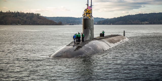 In this Dec. 15, 2016, photo, provided by the U.S. Navy, the Seawolf-class fast-attack submarine USS Connecticut (SSN 22) departs Puget Sound Naval Shipyard for sea trials following a maintenance availability. A Navy official says a submarine that collided with an unknown underwater object in the South China Sea has arrived in port at Guam. The Navy says the USS Connecticut was conducting routine operations when it struck the object on Oct. 2, 2021. (Thiep Van Nguyen II/U.S. Navy via AP)