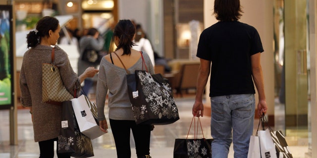 Shoppers carry their purchases during