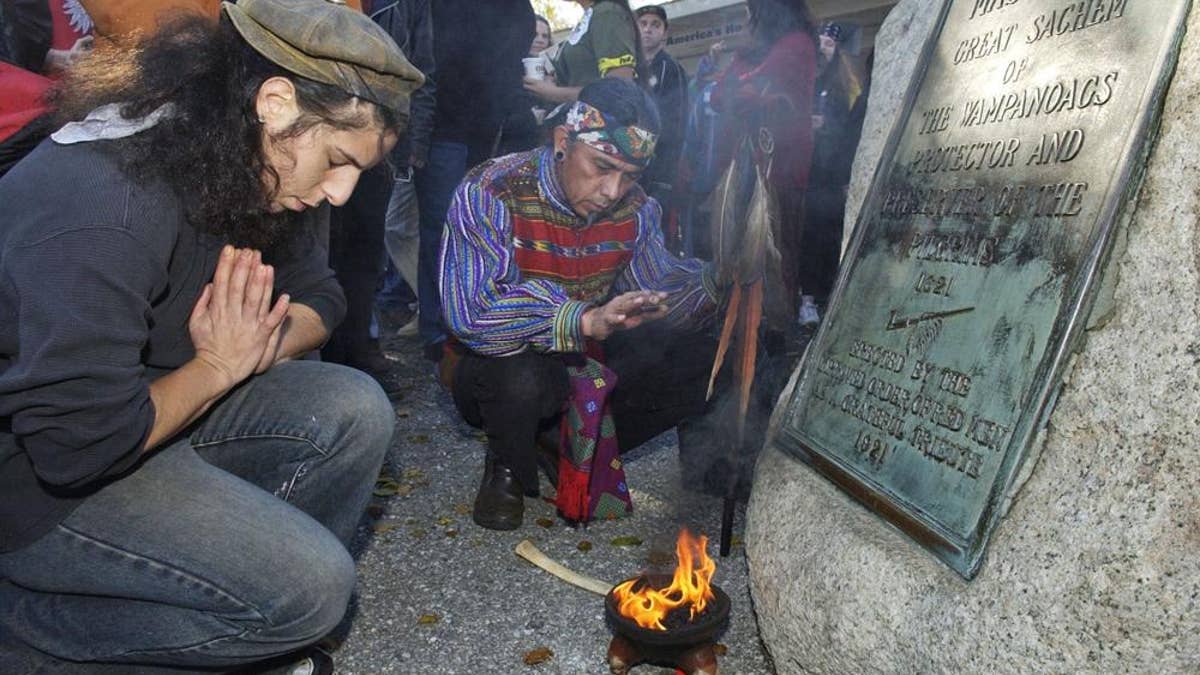 Supporters of Native Americans pause following a prayer during the 38th National Day of Mourning at Coles Hill in Plymouth, Mass., on Nov. 22, 2007. Denouncing centuries of racism and mistreatment of Indigenous people, members of Native American tribes from around New England will gather on Thanksgiving 2021 for a solemn National Day of Mourning observance.