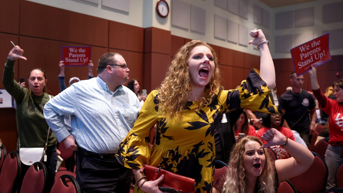 Angry parents and community members protest after a Loudoun County School Board meeting was halted by the school board because the crowd refused to quiet down, in Ashburn, Virginia, U.S. June 22, 2021.