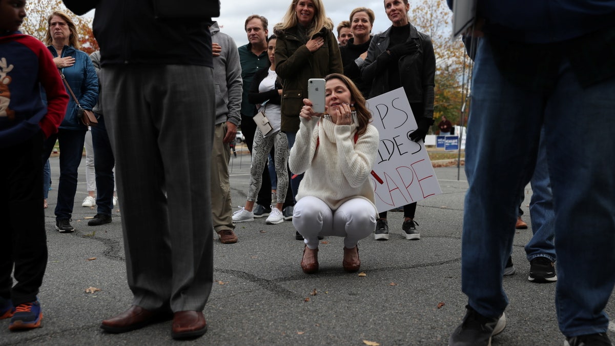 People gather to protest different issues including the board’s handling of a sexual assault that happened in a school bathroom in May, vaccine mandates and critical race theory during a Loudoun County School Board meeting in Ashburn, Virginia, U.S., October 26, 2021. Picture taken October 26, 2021. REUTERS/Leah Millis