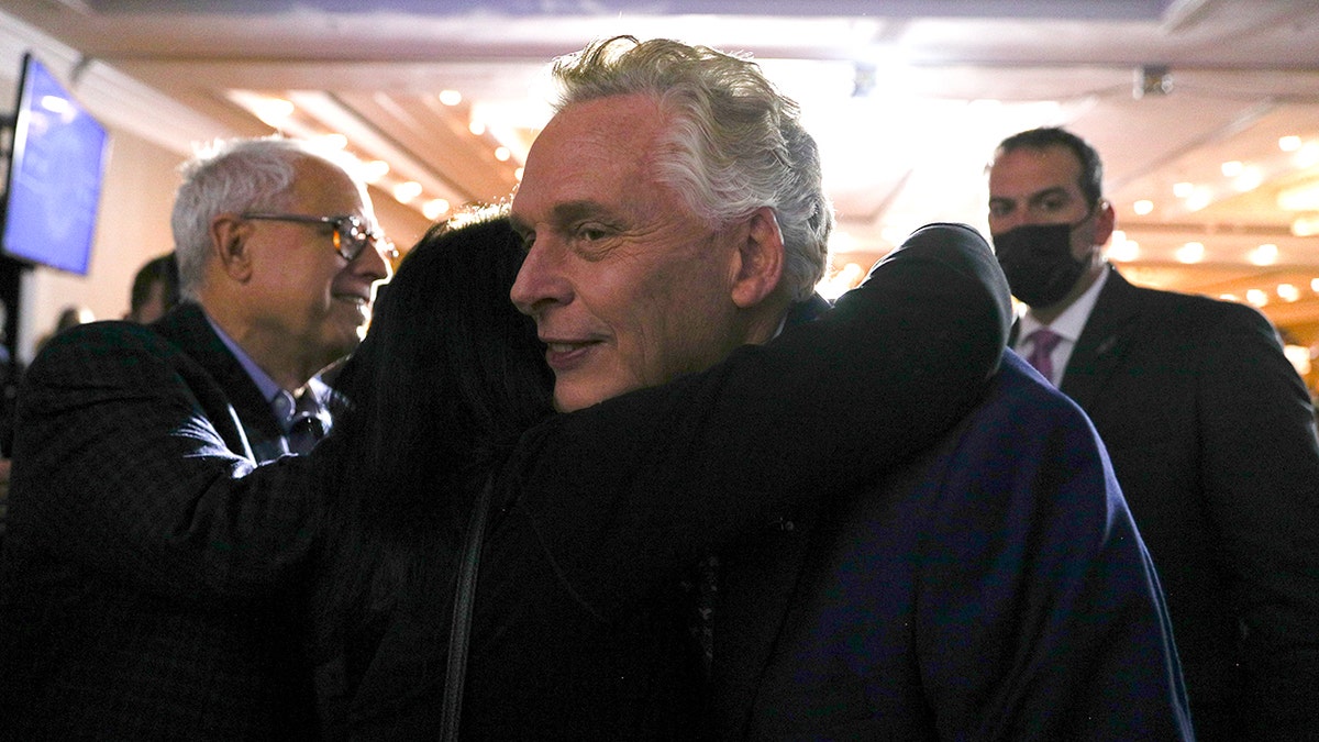 Democratic nominee for Virginia governor Terry McAuliffe is consoled by a supporter in the crowd during his election night party and rally in McLean, Virginia