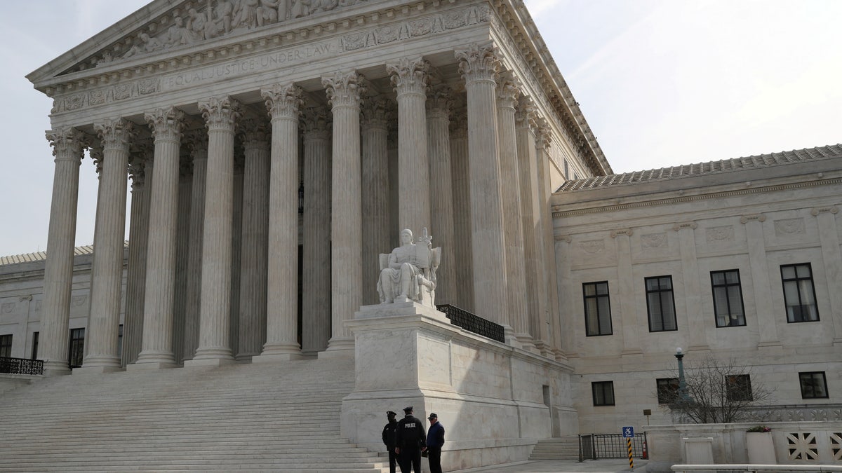 Security guards stand outside the Supreme Court building in Washington on March 20, 2019.