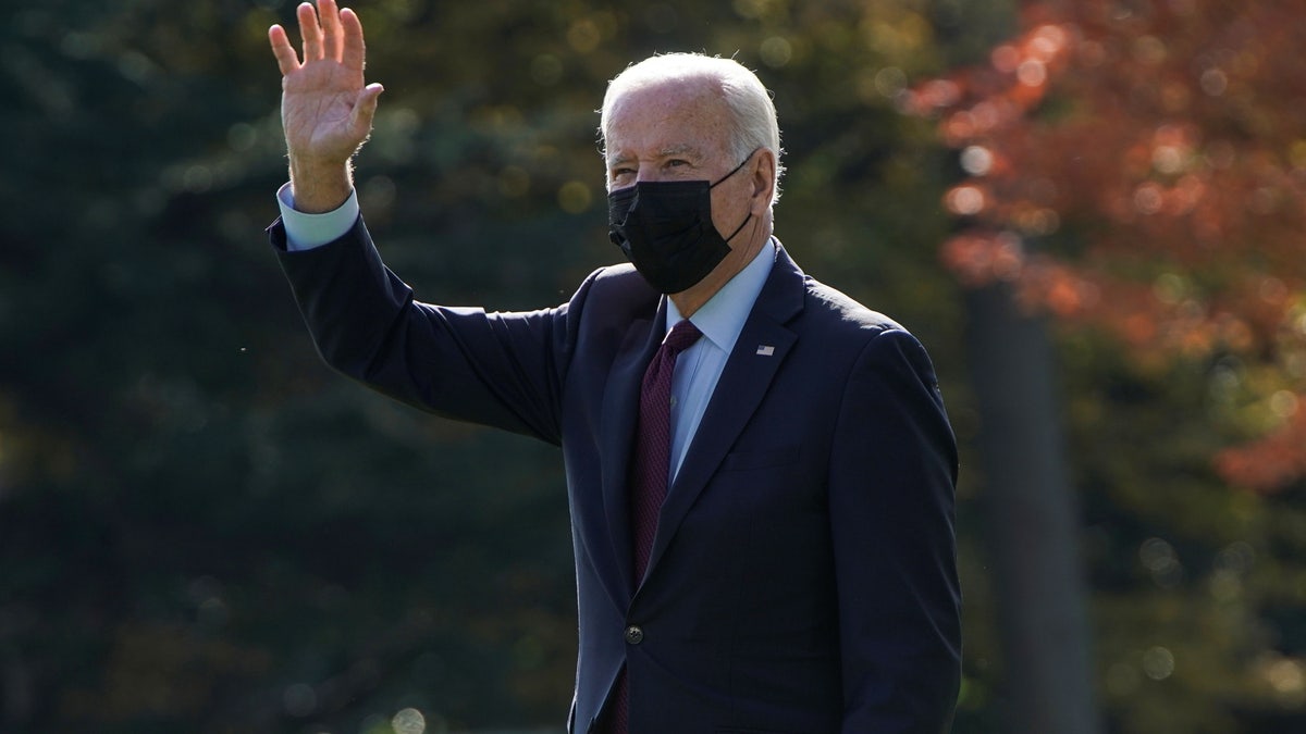 President Joe Biden waves as he walks to Marine One, to depart for Detroit, Michigan, from the White House on November 17, 2021.