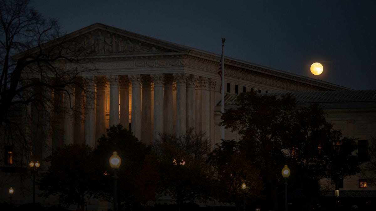 A full moon rises behind the U.S. Supreme Court on Capitol Hill in Washington on Nov. 18, 2021.