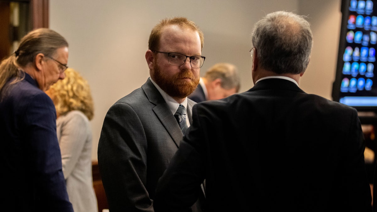 Travis McMichael looks back at his mother and sister in the courtroom after the jury convicted him for the murder of Ahmaud Arbery in the Glynn County Courthouse, in Brunswick, Georgia, Nov. 24, 2021. 
