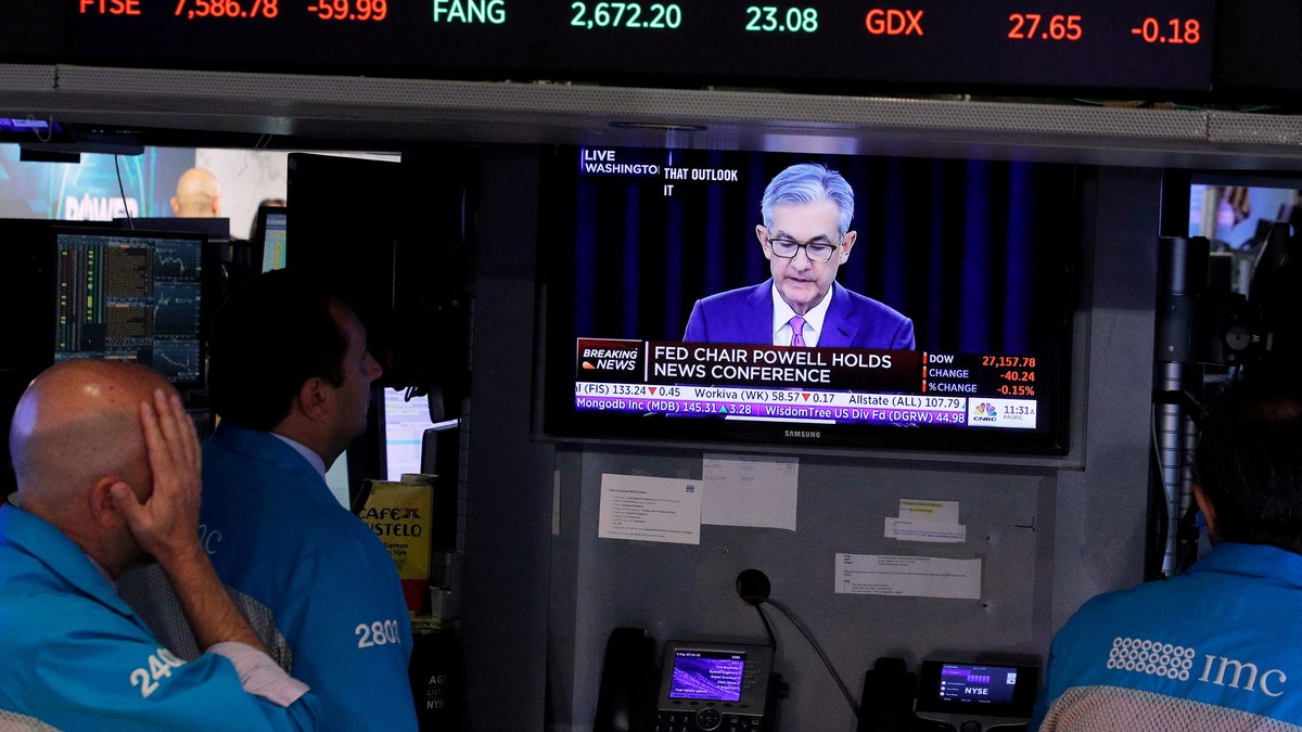 Pictures of television screen of Jerome Powell's announcement from the NY stock exchange.