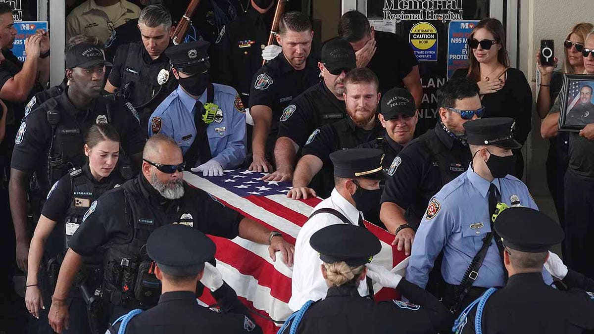 The dignified transfer of the remains of slain Hollywood Police Officer Yandy Chirino takes place at Memorial Regional Hospital in Hollywood, Fla., on Monday Oct. 18, 2021. Chirino was killed during a late-night altercation with a teenage suspect and died at the hospital. 