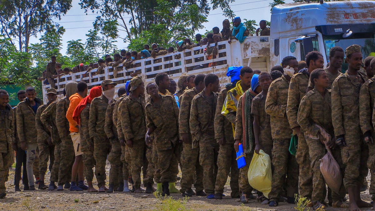 Captured Ethiopian government soldiers and allied militia members line up after being paraded by Tigray forces through the streets in open-top trucks as they arrived to be taken to a detention center in Mekele, the capital of the Tigray region of northern Ethiopia Friday, Oct. 22, 2021. 