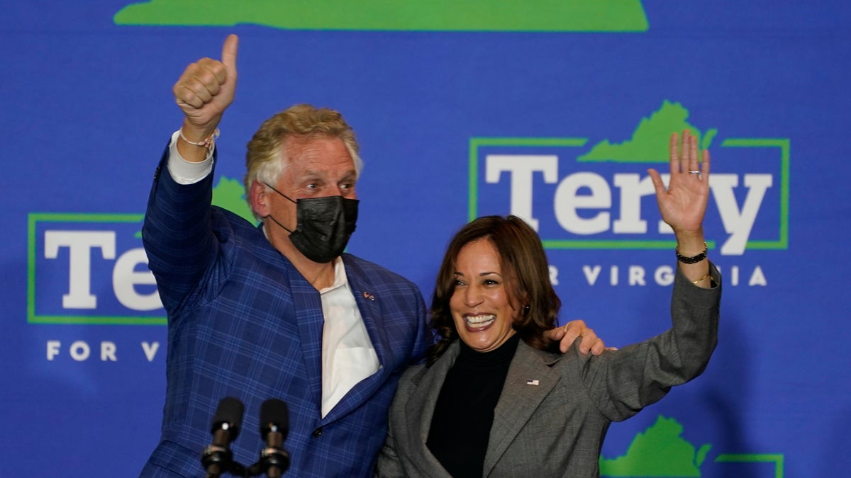 Vice President Kamala Harris waves to the crowd along with Democratic gubernatorial candidate former Gov. Terry McAuliffe during a rally in Norfolk, Va., Friday, Oct. 29, 2021. (AP Photo/Steve Helber)