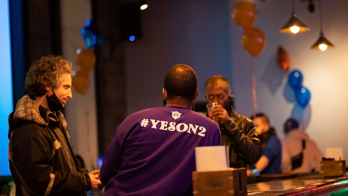 "Yes on 2" supporters watch as the results of the ballot question come in on Election Day during a watch party at the Gold Room Restaurant and Lounge in Minneapolis. Voters in Minneapolis chose not to replace the city's police department with a new Department of Public Safety. The election comes more than a year after George Floyd's death launched a movement to defund or abolish police across the country. (AP Photo/Christian Monterrosa)