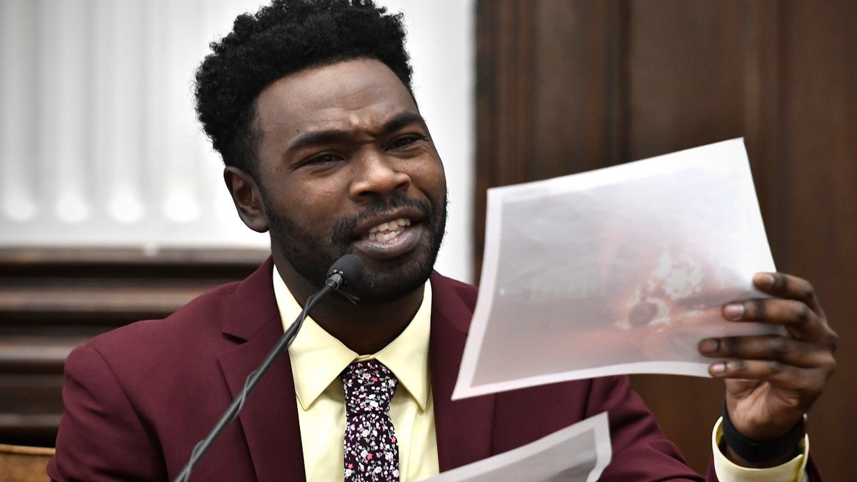 Koerri Washington says he recognizes a photograph of a garbage truck on fire while testifying during Kyle Rittenhouse's trial at the Kenosha County Courthouse on Wednesday, Nov. 3, 2021.