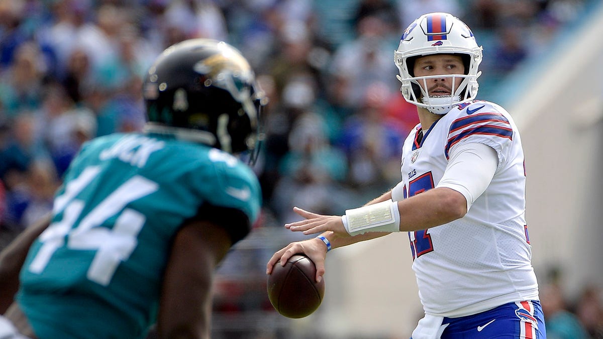Buffalo Bills quarterback Josh Allen looks for a receiver as Jacksonville Jaguars linebacker Myles Jack (44) puts on pressure during the first half Sunday, Nov. 7, 2021, in Jacksonville, Fla.