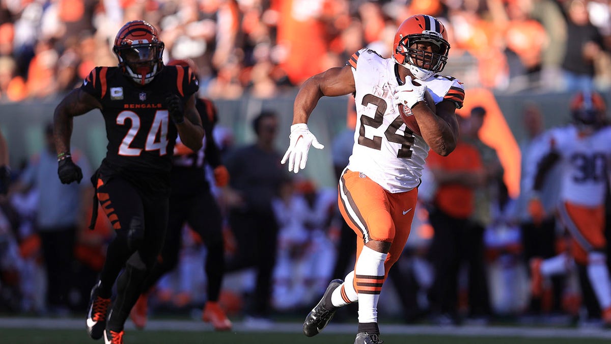 Cleveland Browns' Nick Chubb (24) runs past Cincinnati Bengals' Vonn Bell (24) for a touchdown during the second half of an NFL football game, Sunday, Nov. 7, 2021, in Cincinnati. 