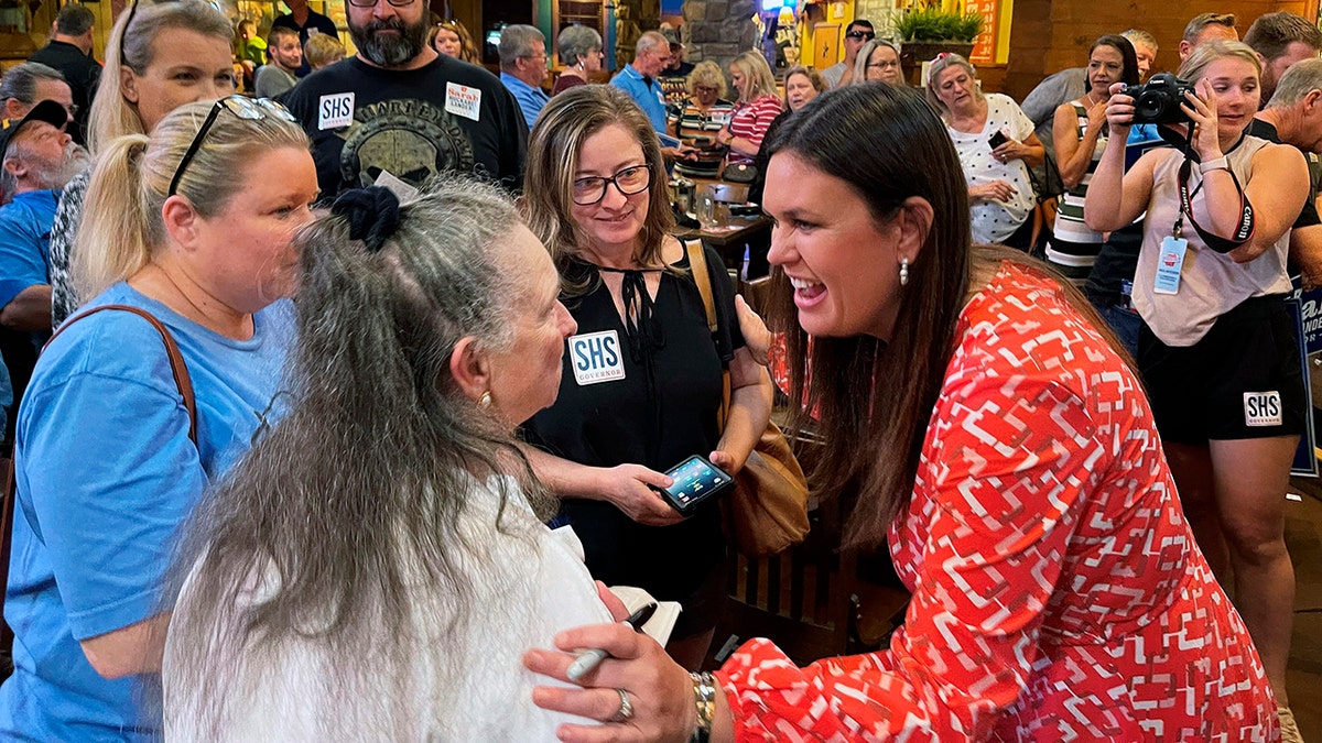 Sarah Huckabee Sanders smiles while meeting with voters