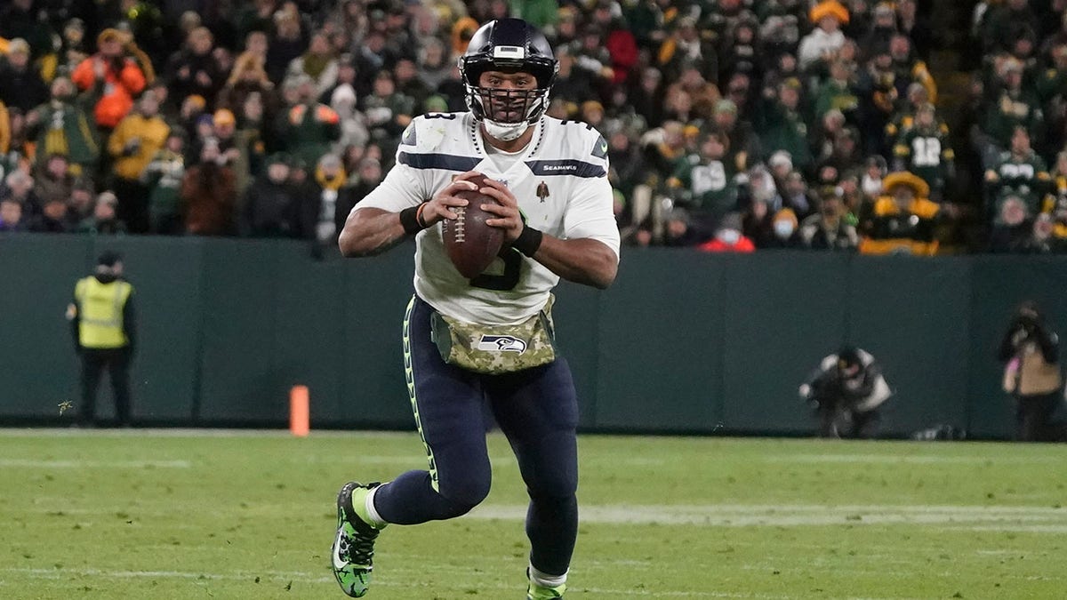 Seattle Seahawks' Russell Wilson scrambles during the second half of an NFL football game against the Green Bay Packers Sunday, Nov. 14, 2021, in Green Bay, Wis.