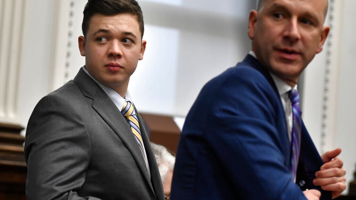 Kyle Rittenhouse, left, and his attorney, Corey Chirafisi, stand after meeting with Judge Bruce Schroeder for questions on video the jury has asked for while it deliberates at the Kenosha County Courthouse in Kenosha, Wis., on Wednesday, Nov. 17, 2021. (Sean Krajacic/The Kenosha News via AP, Pool)
