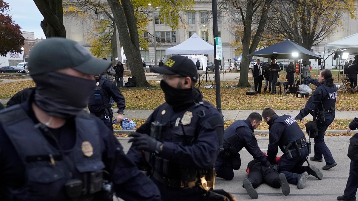 A protester is taken into custody by police outside the Kenosha County Courthouse, Wednesday, Nov. 17, 2021 in Kenosha, Wis., during the Kyle Rittenhouse murder trial. (AP Photo/Paul Sancya)