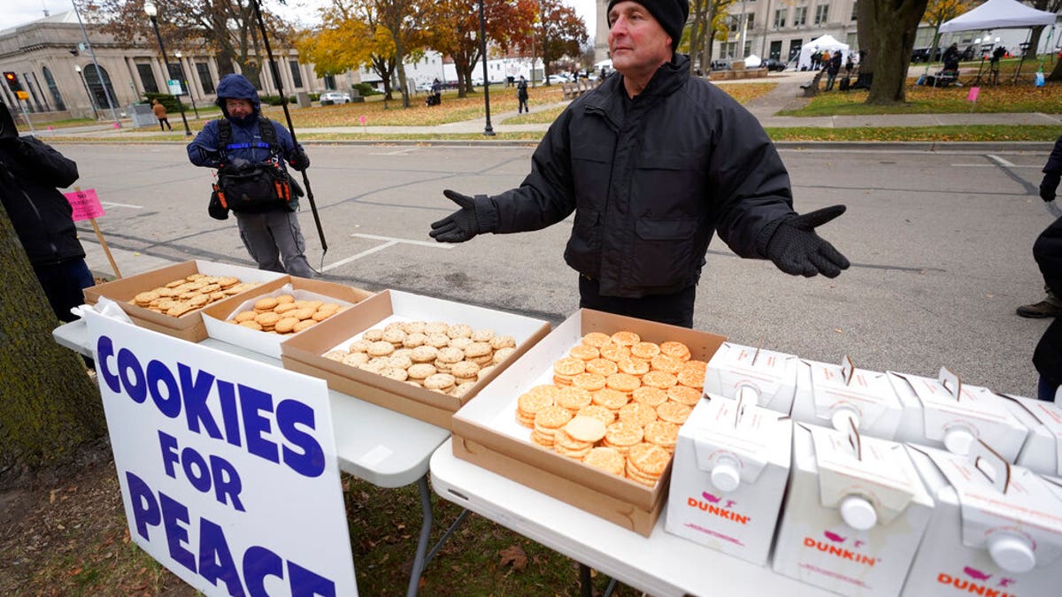 Kenosha County Sheriff David Beth offers cookies and coffee outside the Kenosha County Courthouse, Thursday, Nov. 18, 2021 in Kenosha, Wis., during the Kyle Rittenhouse murder trial. Rittenhouse is accused of killing two people and wounding a third during a protest over police brutality in Kenosha, last year. (AP Photo/Paul Sancya)