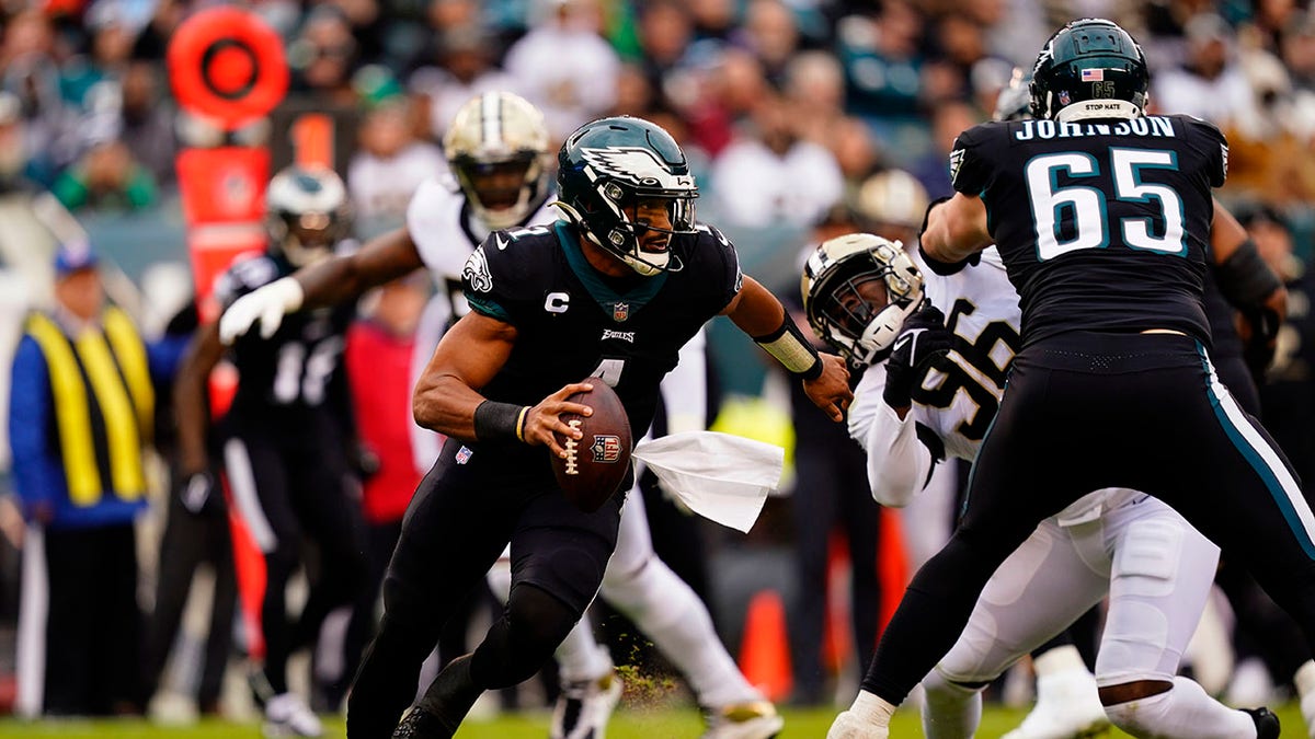 Philadelphia Eagles' Jalen Hurts scrambles during the first half of an NFL football game against the New Orleans Saints, Sunday, Nov. 21, 2021, in Philadelphia.