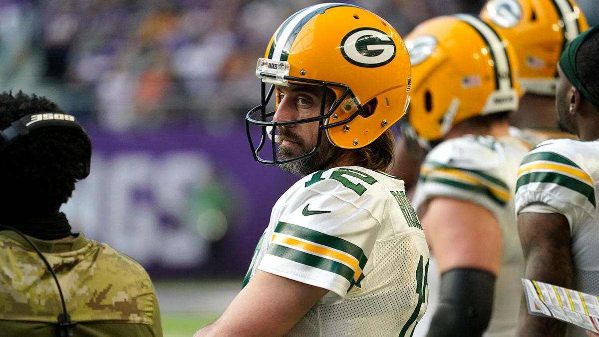 Green Bay Packers quarterback Aaron Rodgers (12) stands on the sideline during the second half of an NFL football game against the Minnesota Vikings, Sunday, Nov. 21, 2021, in Minneapolis.