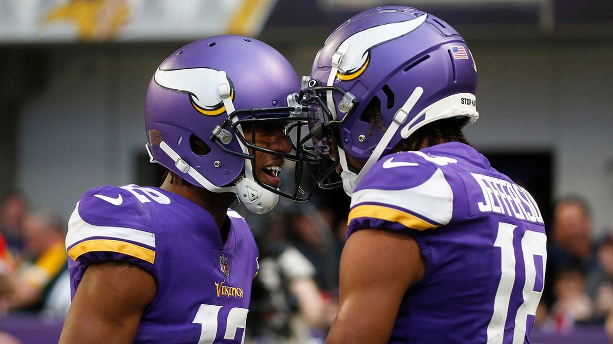 Minnesota Vikings wide receiver Justin Jefferson (18) celebrates with teammate Dede Westbrook (12) after catching a 23-yard touchdown pass during the second half against the Green Bay Packers, Sunday, Nov. 21, 2021, in Minneapolis.