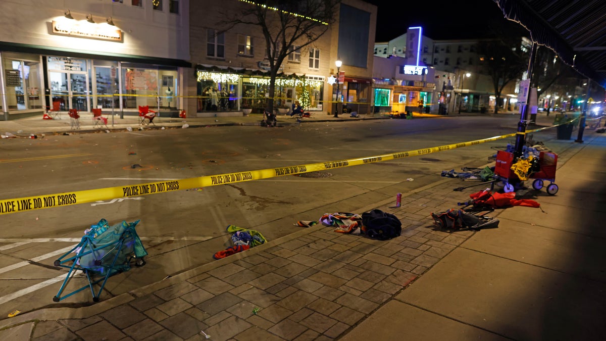 Police tape cordons off a street in Waukesha, Wis., after an SUV plowed into a Christmas parade hitting multiple people Sunday, Nov. 21, 2021. 
