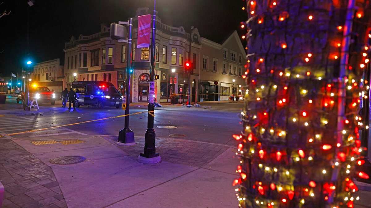 Police canvass the streets in downtown Waukesha, Wis., after a vehicle plowed into a Christmas parade hitting multiple people Sunday, Nov. 21, 2021. (AP Photo/Jeffrey Phelps)