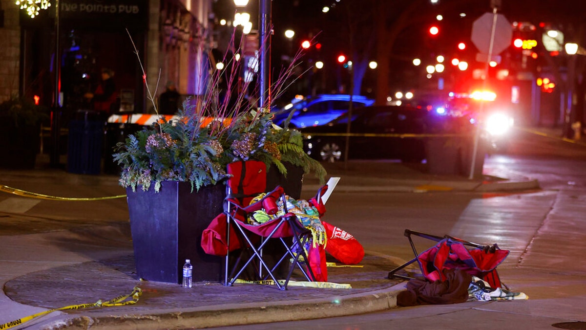 Toppled chairs are seen among holiday decorations in downtown Waukesha, Wis., after an SUV plowed into a Christmas parade injuring dozens of people Sunday, Nov 21. 2021. (AP Photo/Jeffrey Phelps)