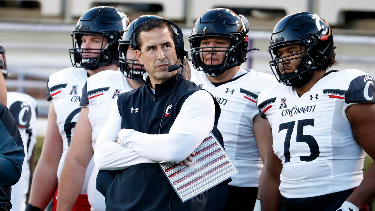 Cincinnati head coach Luke Fickell watches from the sidelines during the first half of an NCAA college football game against East Carolina in Greenville, N.C., Friday, Nov. 26, 2021. 
