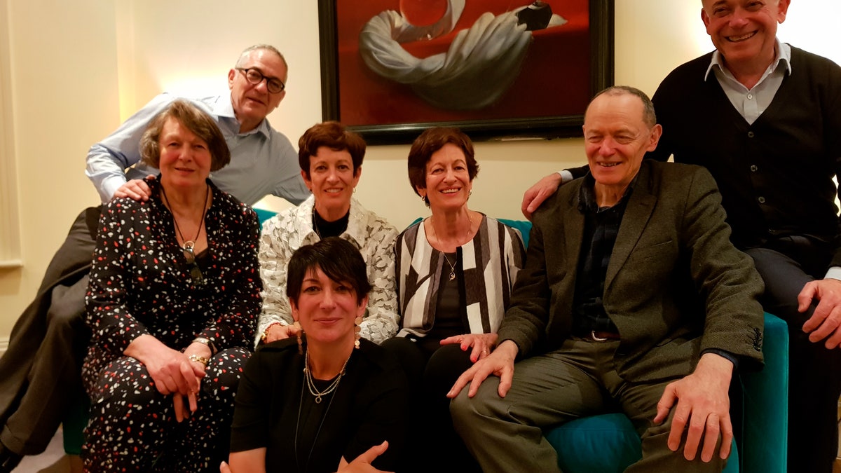 In this undated photo provided by the Maxwell family, Ghislaine Maxwell, center bottom, poses for a photo with siblings, from left to right: Anne, Kevin, Isabel, Christine, Philip and Ian. After a life of both scandal and luxury, Maxwell's next act will be decided by a U.S. trial. Starting Monday, prosecutors in New York will argue that even as she was sipping cocktails with the likes of Prince Andrew, Bill Clinton and Donald Trump, Maxwell, 59, was secretly abetting Epstein's crimes with girls as young as 14. (Courtesy of the Maxwell Family via AP)