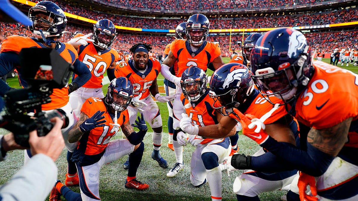 The Denver Broncos defense celebrates cornerback Pat Surtain II's interception during the second half of an NFL football game against the Los Angeles Chargers on Sunday, Nov. 28, 2021, in Denver.