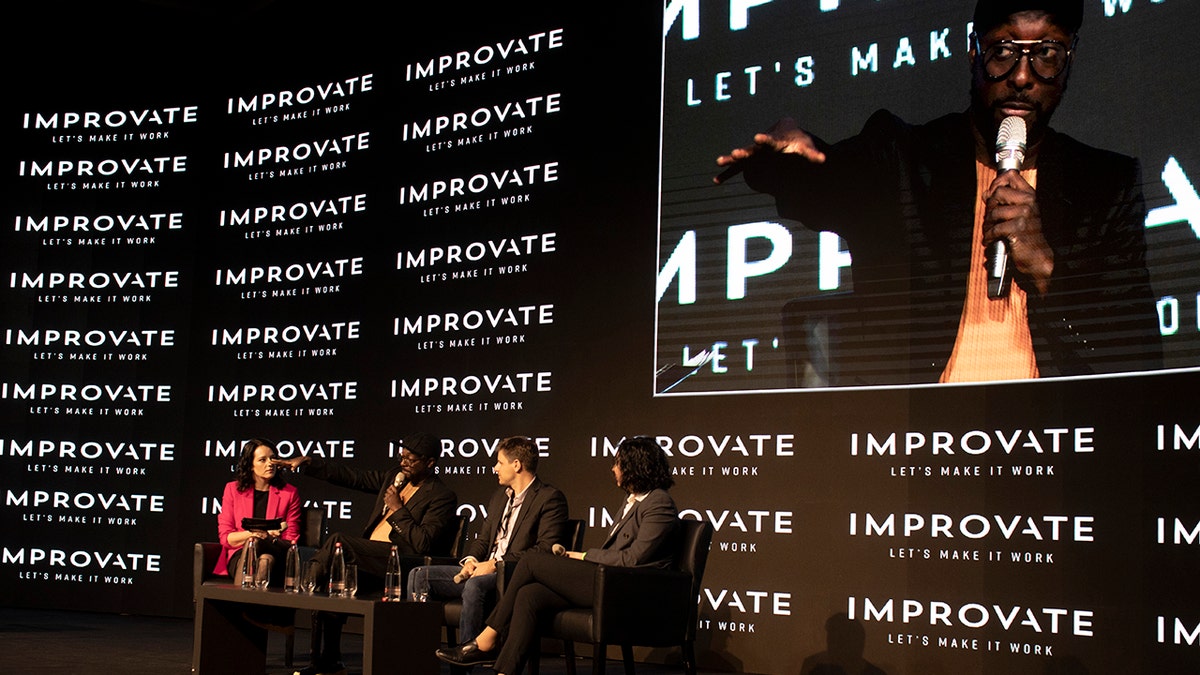 American musician will.i.am, front man for Black Eyed Peas, second left, speaks on a panel at an innovation conference held by Improvate, in Jerusalem, Monday, Nov. 29, 2021. 