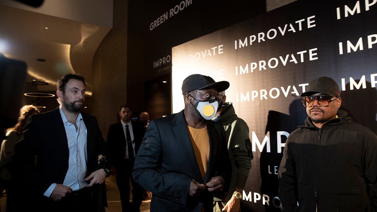 American musician will.i.am, center, arrives for a photo op with his Black Eyed Peas bandmates at the Improvate International Innovation Forum in Jerusalem, Monday, Nov. 29, 2021.?