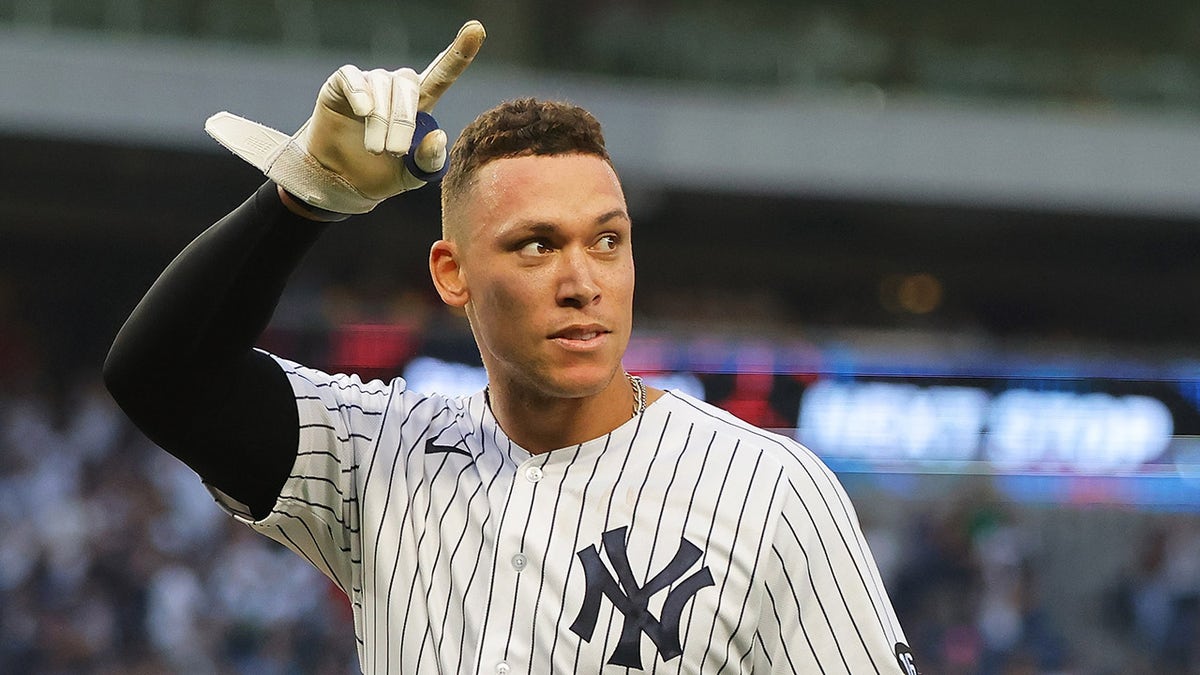 Aaron Judge #99 of the New York Yankees celebrates after hitting a walk-off single in the bottom of the ninth inning to beat the Tampa Bay Rays 1-0 at Yankee Stadium on October 03, 2021 in New York City.