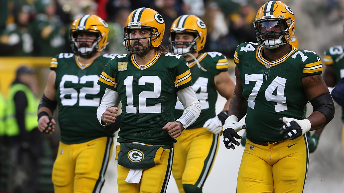 GREEN BAY, WI - NOVEMBER 14: Green Bay Packers quarterback Aaron Rodgers (12) leads the team onto the field during a game between the Green Bay Packers and the Seattle Seahawks at Lambeau Field on November 14, 2021 in Green Bay, WI.