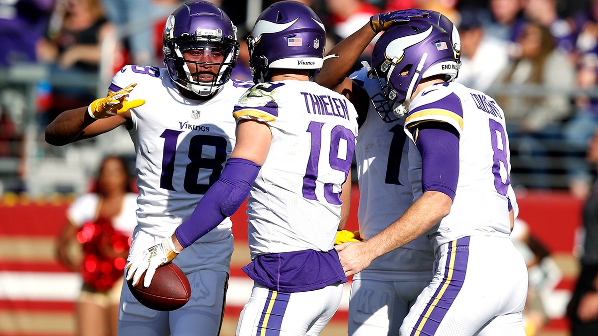 Adam Thielen (19) of the Minnesota Vikings celebrates with Justin Jefferson (18) and Kirk Cousins (8) after scoring on a touchdown reception in the first quarter against the San Francisco 49ers at Levi's Stadium Nov. 28, 2021 in Santa Clara, Calif.