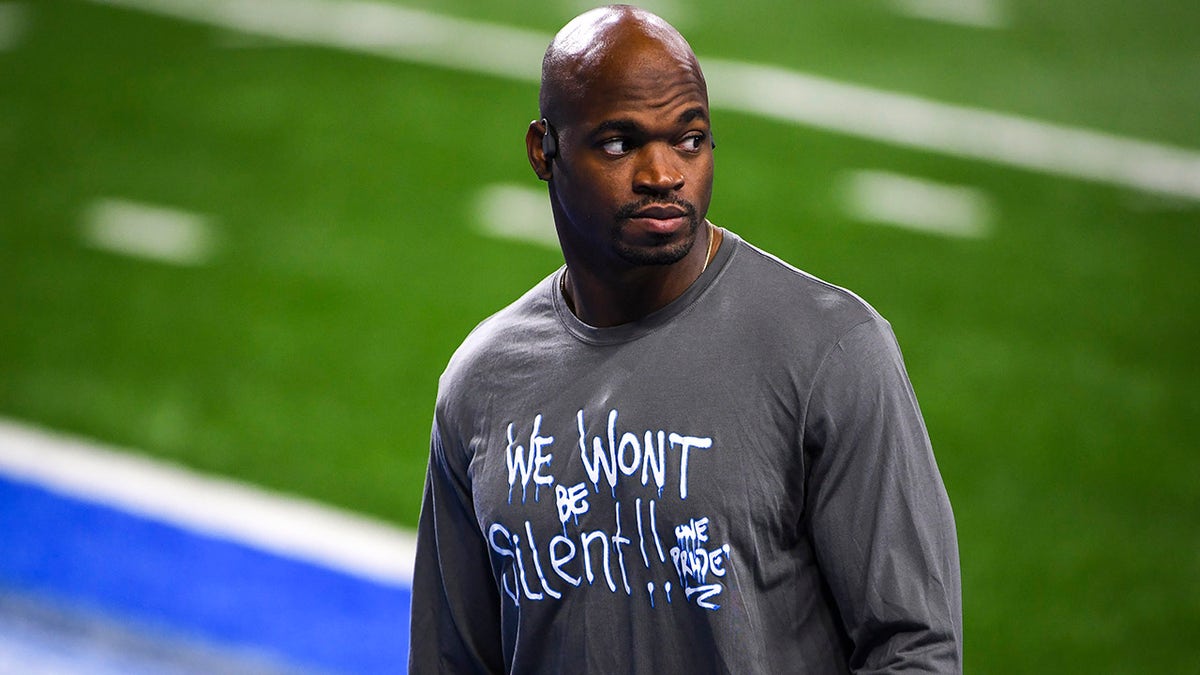 Adrian Peterson looks on