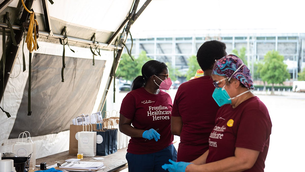 Health care workers prepare to administer doses of the Pfizer-BioNTech Covid-19 vaccine during a vaccination event in Birmingham, Alabama, U.S., on Saturday, Aug. 28, 2021. Photographer: Andi Rice/Bloomberg via Getty Images