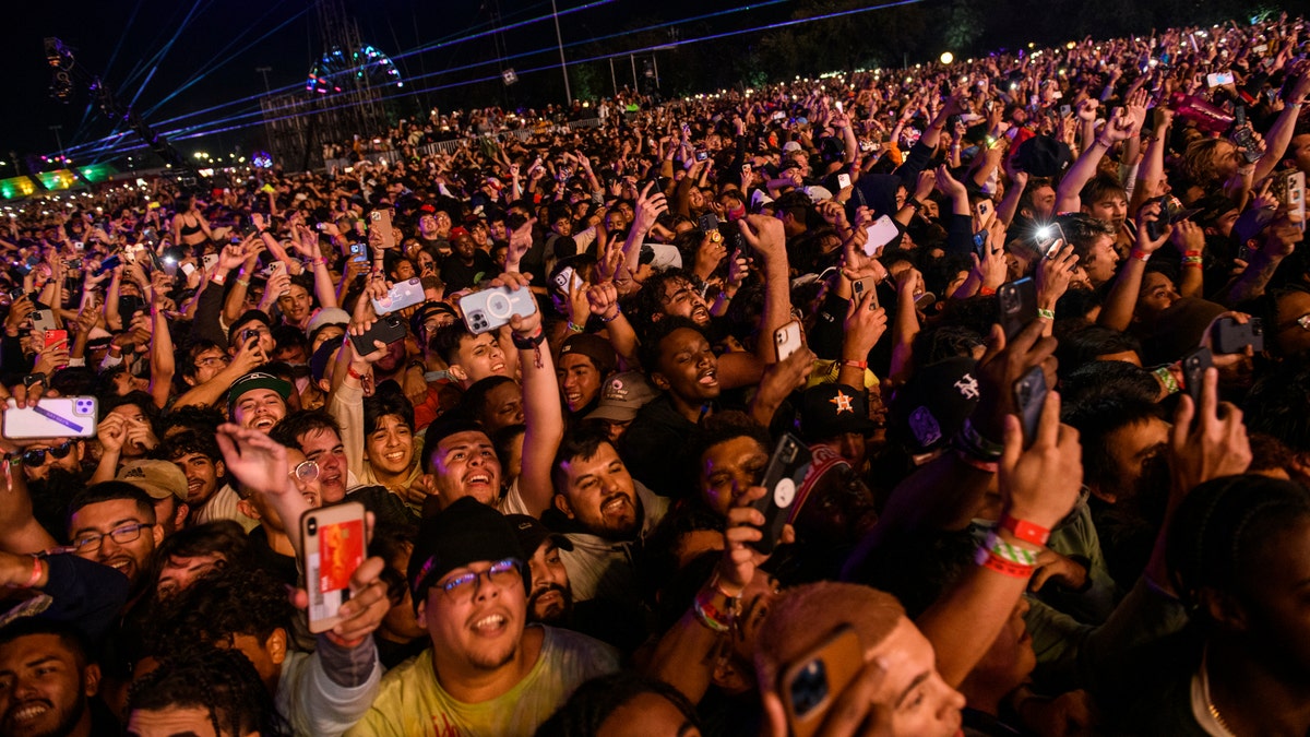 The crowd watches as Travis Scott performs at Astroworld Festival at NRG Park in Houston, Nov. 5, 2021.