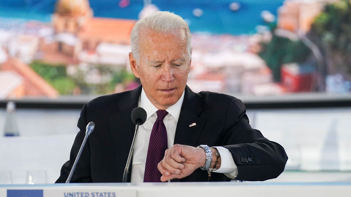 President Biden checks his watch during an event on global supply chain resilience through the coronavirus pandemic and recovery on the sidelines of the G20 leaders' summit in Rome Oct. 31, 2021.