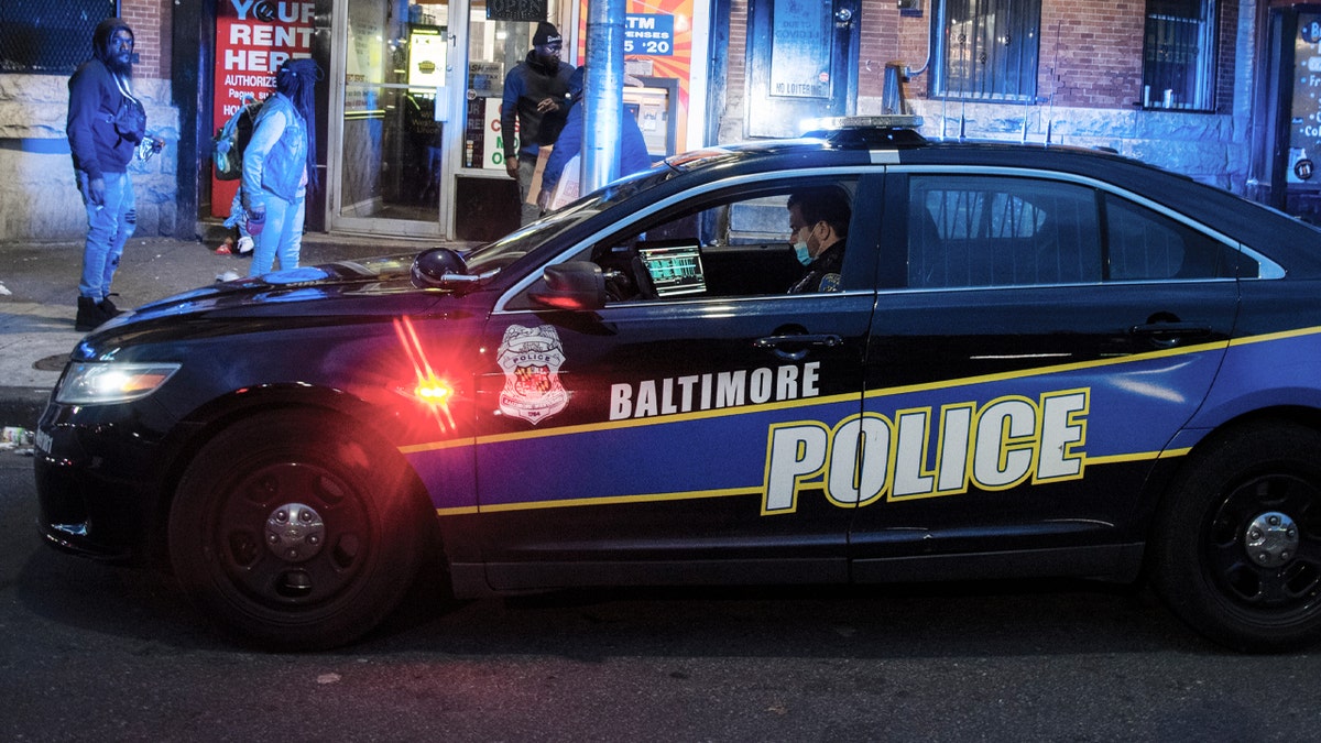 A Baltimore police officer posts himself near the intersection of W. North Avenue and Pennsylvania Avenue in West Baltimore, Maryland. 