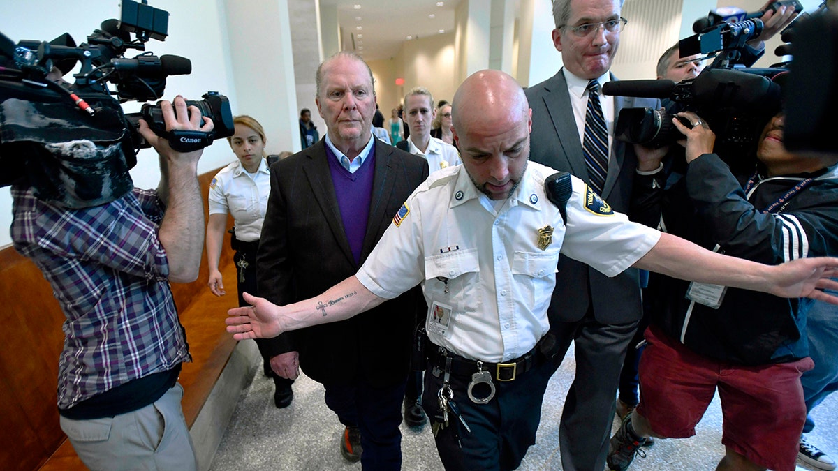 Celebrity chef Mario Batali, center left, departs after pleading not guilty in May 2019 at Boston Municipal Court.