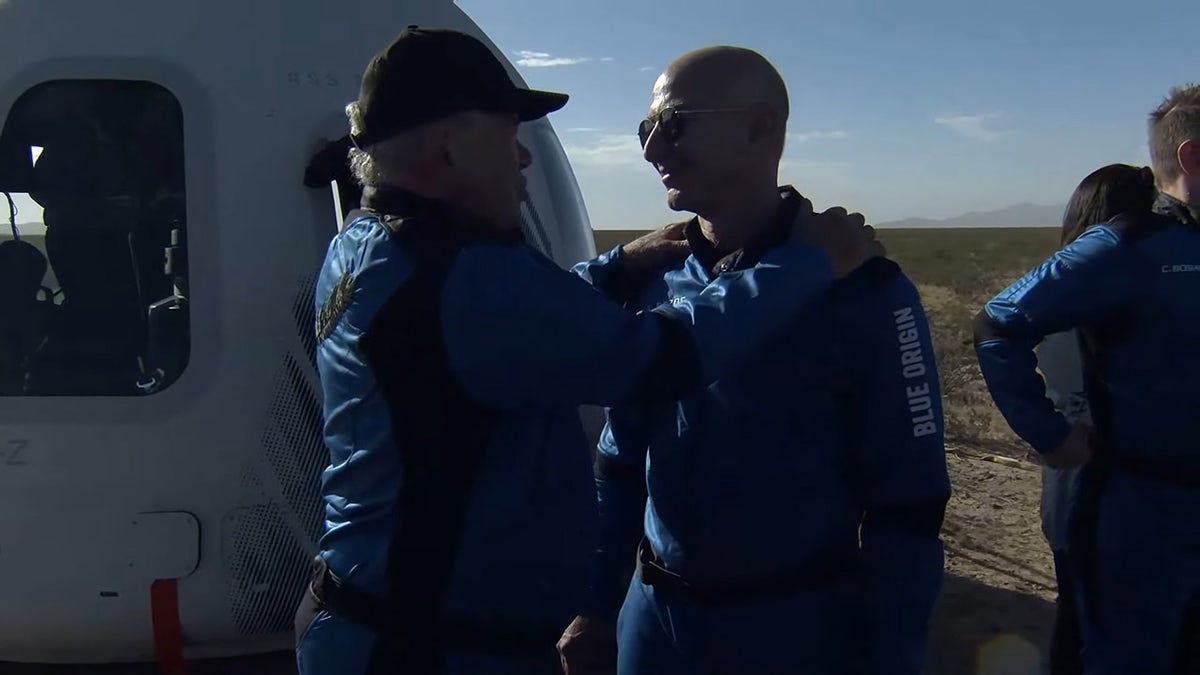 BLUE ORIGIN / HANDOUT A screenshot taken from a live handout video on October 13, 2021 shows Jeff Bezos talks to William Shatner after Blue Origin's New Shepard crew capsule landed back in Texas. (Photo by Blue Origin/Anadolu Agency via Getty Images)
